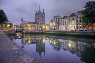 Reflection of buildings in lake at night