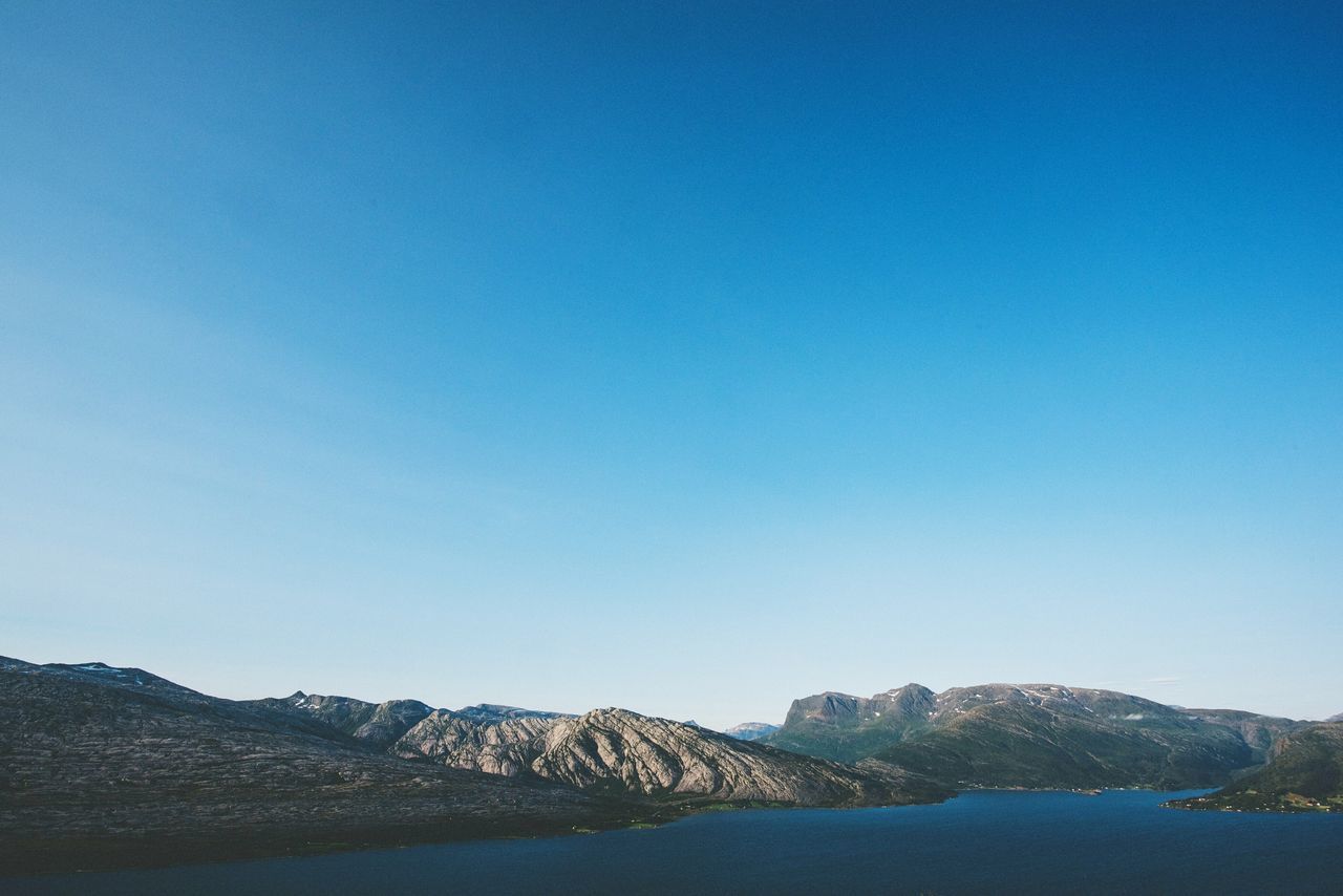 clear sky, copy space, blue, tranquil scene, tranquility, mountain, scenics, beauty in nature, water, nature, landscape, mountain range, idyllic, non-urban scene, day, remote, outdoors, no people, lake, horizon over land