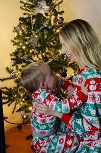 Full length of woman with christmas tree