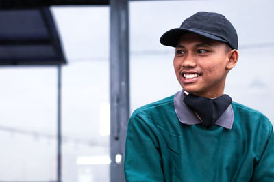 Portrait of smiling young man standing outdoors