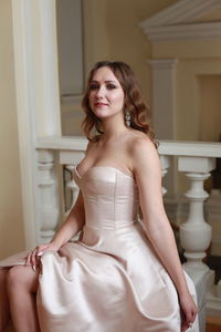 Beautiful young woman sitting indoors