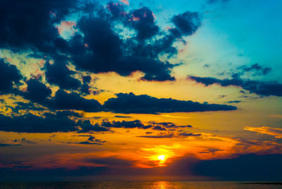Scenic view of dramatic sky over sea during sunset