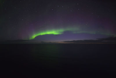 Scenic view of lake against sky at night