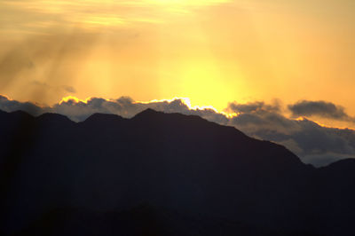 Low angle view of mountains against dramatic sky