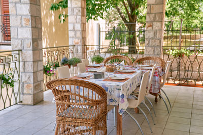 Empty chairs and tables in back yard