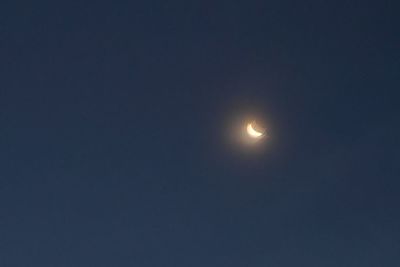 Low angle view of moon against sky at night