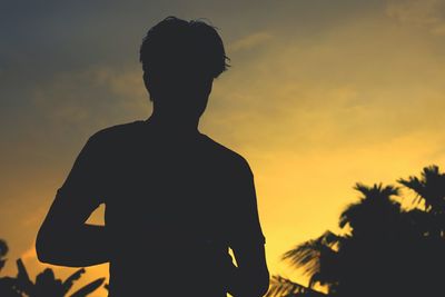 Silhouette man against yellow sky during sunset