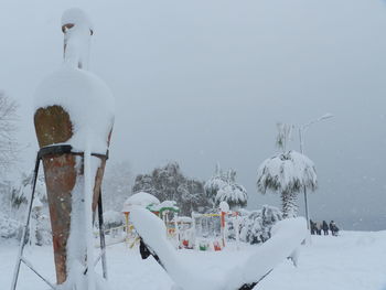 Panoramic view of snow covered field against sky