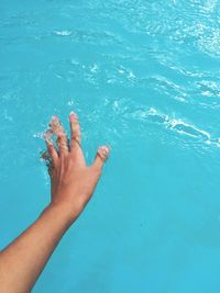 Close-up of hand touching water