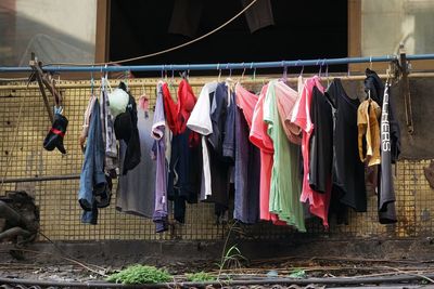 Clothes drying on pipe against building