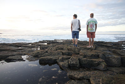 Two men looking at sea