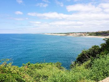 Scenic view of calm sea against cloudy sky