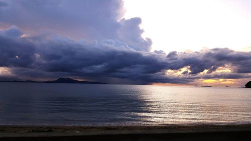 Scenic view of calm sea against cloudy sky