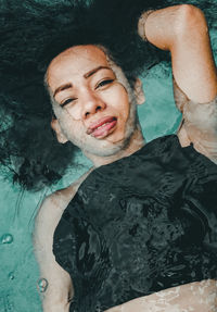 High angle portrait of young woman in swimming pool