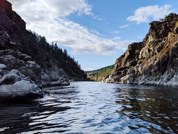 Scenic view of river amidst mountains against sky