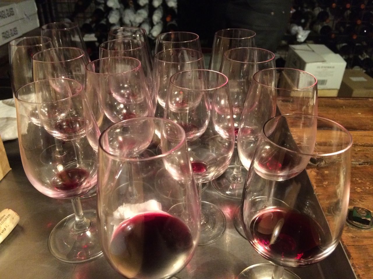 CLOSE-UP OF WINE GLASSES ON GLASS TABLE