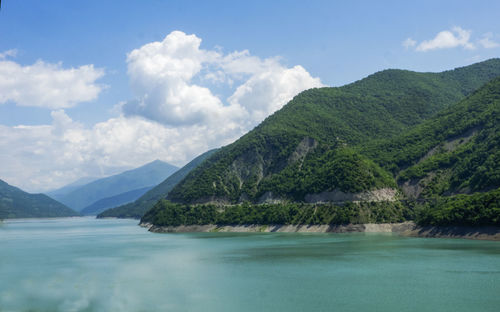 Scenic view of lake and mountains against sky