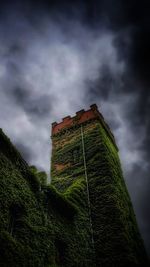 Low angle view of old building against cloudy sky