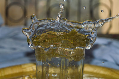 Close-up of water splashing in glass