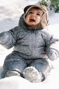 Baby boy screaming on snow covered field