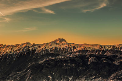 Scenic view of snowcapped mountains against sky during sunset