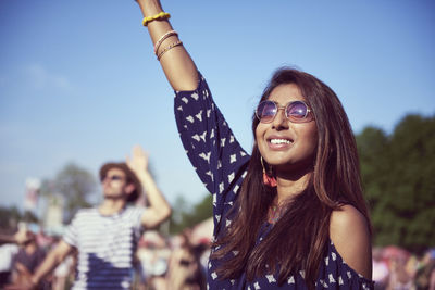 Smiling young woman enjoying party during sunny day