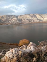 Scenic view of lake and mountains against sky