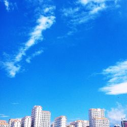 Low angle view of buildings against blue sky