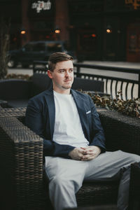 Young man sitting on seat