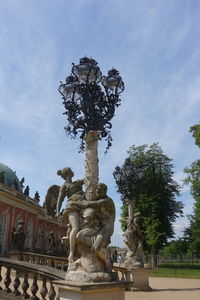 Low angle view of angel statue against sky