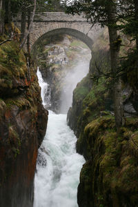 Scenic view of river flowing through rocks
