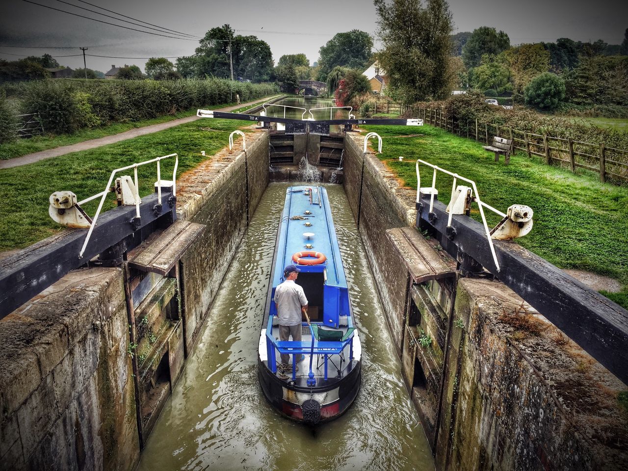 transportation, mode of transport, water, nautical vessel, boat, river, land vehicle, tree, high angle view, travel, men, waterfront, nature, day, lifestyles, canal, outdoors, green color