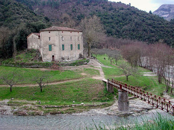 Built structure on field against mountain