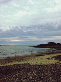 Scenic view of sea against cloudy sky