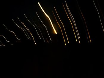 Low angle view of firework display against sky at night