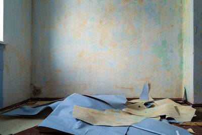 Close-up of messy table against wall at home