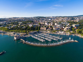 High angle view of buildings by sea against sky