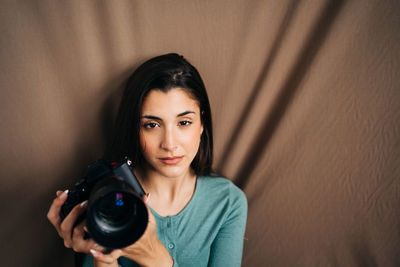 Portrait of woman photographing