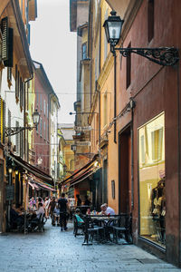 People on street amidst buildings in city