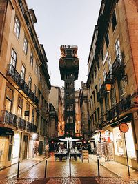 Street amidst buildings in city against sky