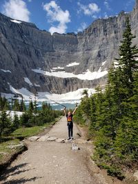 Full length of girl standing against mountain on footpath