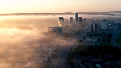 High angle view of buildings in city at sunset