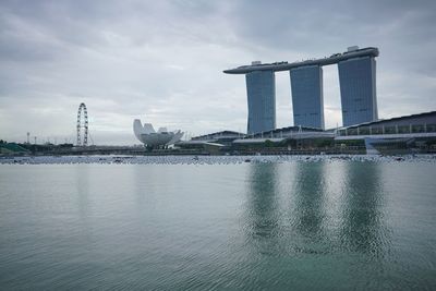 Marina bay sands against cloudy sky