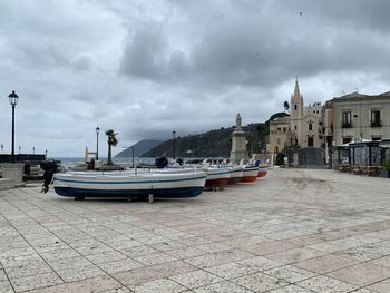 Boats in canal amidst buildings in city