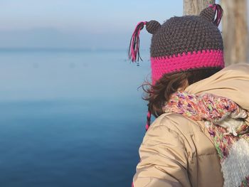 Rear view of woman looking at sea against sky