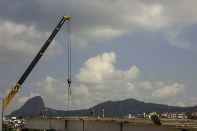 Low angle view of crane against sky