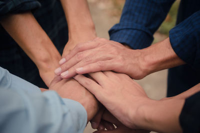 Midsection of couple holding hands