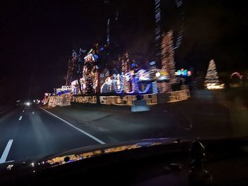 Illuminated car on road in city at night