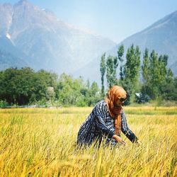 Portrait of woman on field against mountain range