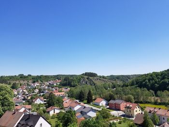 High angle view of townscape against clear blue sky